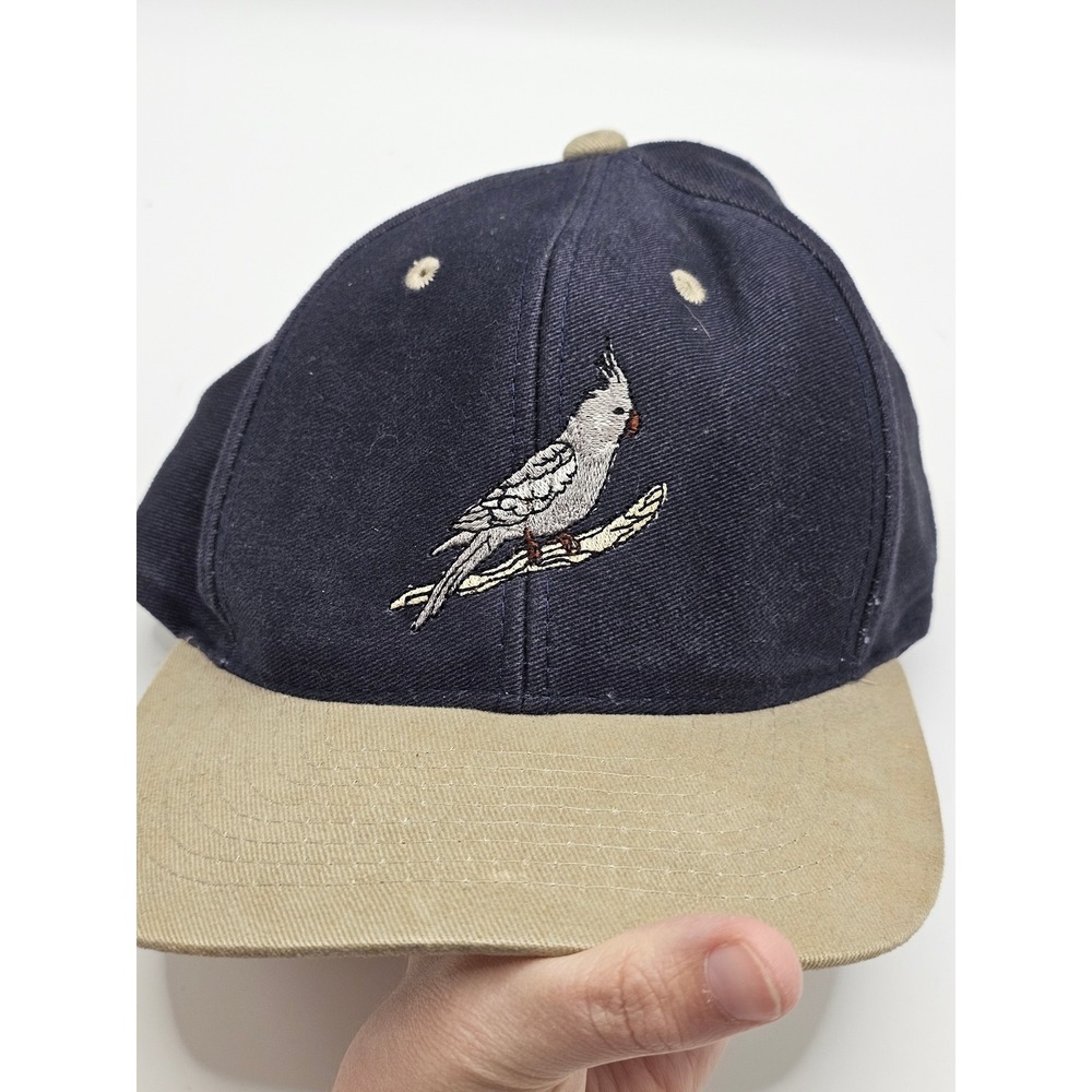 navy blue and tan embroidered baseball cap featuring a cockatiel design vintage